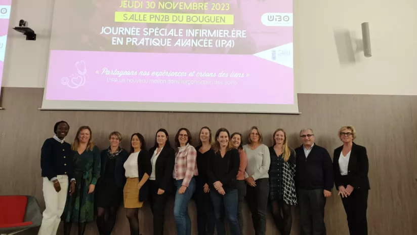 Equipe de la journée IPA posant devant l'affiche